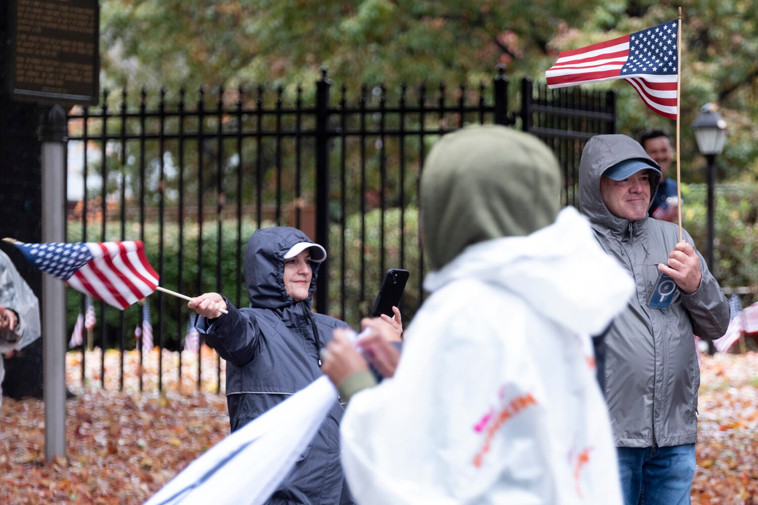 Dianne and Rick Almand wave flags while watching the 42nd annual Georgia Veteran’s Day Parade in Midtown Atlanta on Saturday, Nov. 11, 2023.   (Ben Gray / Ben@BenGray.com)