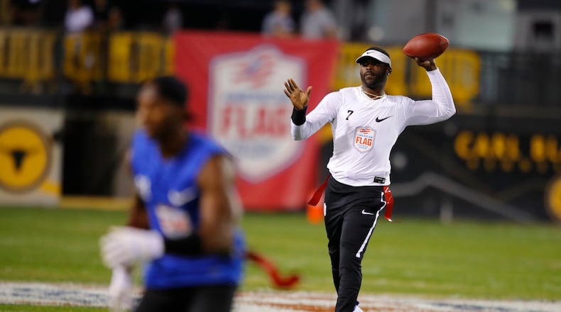 Michael Vick - remember him? - lets loose an uncontested pass Saturday night at Kennesaw State. (Todd Kirkland/AP Images for American Flag Football League)