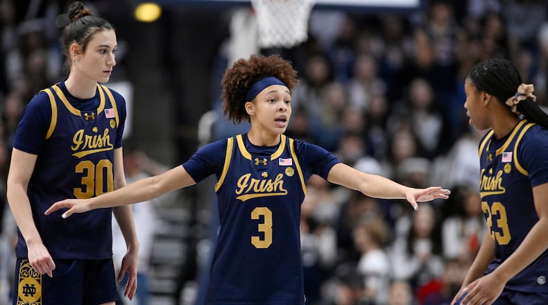 FILE - Notre Dame guard Hannah Hidalgo (3) talks with teammates Gisela Sanchez (30) and Iyana Moore (23) in the second half of an NCAA college basketball game against UConn, Monday, Jan. 19, 2026, in Storrs, Conn. (AP Photo/Jessica Hill)