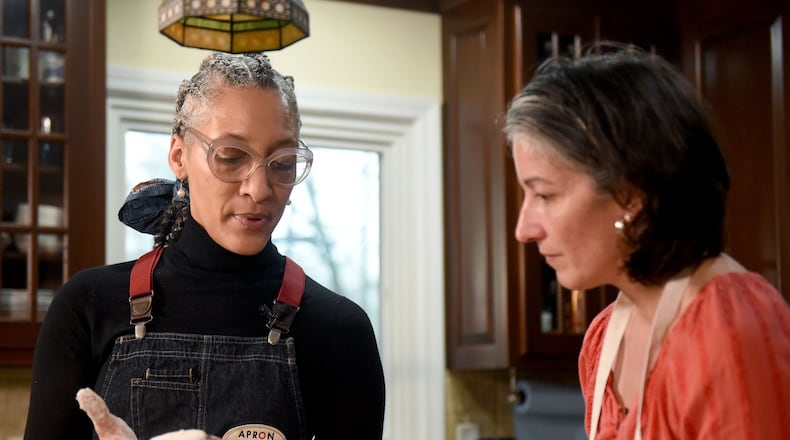 February 22, 2019 Atlanta - Top Chef Carla Hall (left) shows the AJCâs Ligaya Figueras (right) the texture of a good biscuit. Ligaya hosted Hall and food expert Chadwick Boyd at her home, where the two shared tips with Ligaya on how to make the best biscuits. RYON HORNE / RHORNE@AJC.COM