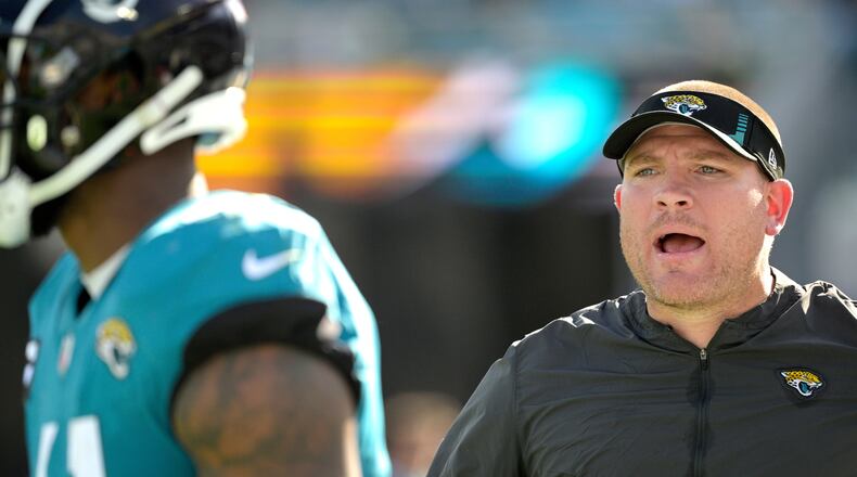 FILE -Jacksonville Jaguars defensive line coach Tosh Lupoi, right, calls out instructions on the sideline during the second half of an NFL football game against the Indianapolis Colts, Jan. 9, 2022, in Jacksonville, Fla. (AP Photo/Phelan M. Ebenhack, File)