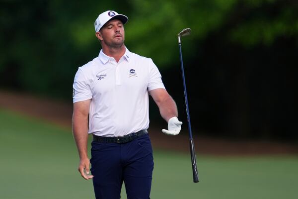 Bryson DeChambeau tosses his club on the 12th hole during the third round at the Masters golf tournament, Saturday, April 12, 2025, in Augusta, Ga. (AP Photo/Matt Slocum)