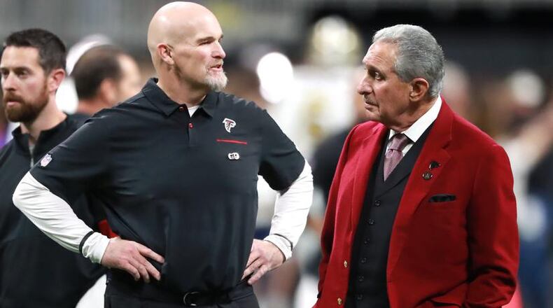 Falcons owner Arthur Blank (right) and coach Dan Quinn confer on the field before playing the New Orleans Saints on Thursday, November 28, 2019, at Mercedes-Benz Stadium. Curtis Compton/ccompton@ajc.com