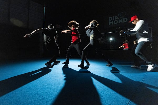 Stunt actors Justin Ortiz (from left), Brandon Martinez and Jess Durham are filmed by director of photography Corey Lincoln, right, as they rehearse a fight scene at the Diamond Action Design Studio. (Jason Getz/AJC)