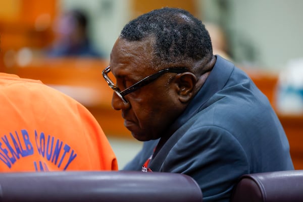 Defense attorney Averick Walker speaks to his client, Wesley Cooley, during his plea hearing at DeKalb County Courthouse in Decatur on Thursday, March 12, 2026. (Arvin Temkar/AJC)