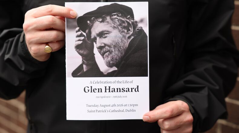 The Order of Service is held up ahead of the funeral of Glen Hansard at St Patrick's Cathedral in Dublin, Tuesday, Aug. 4, 2026. (Damien Eagers/PA via AP)