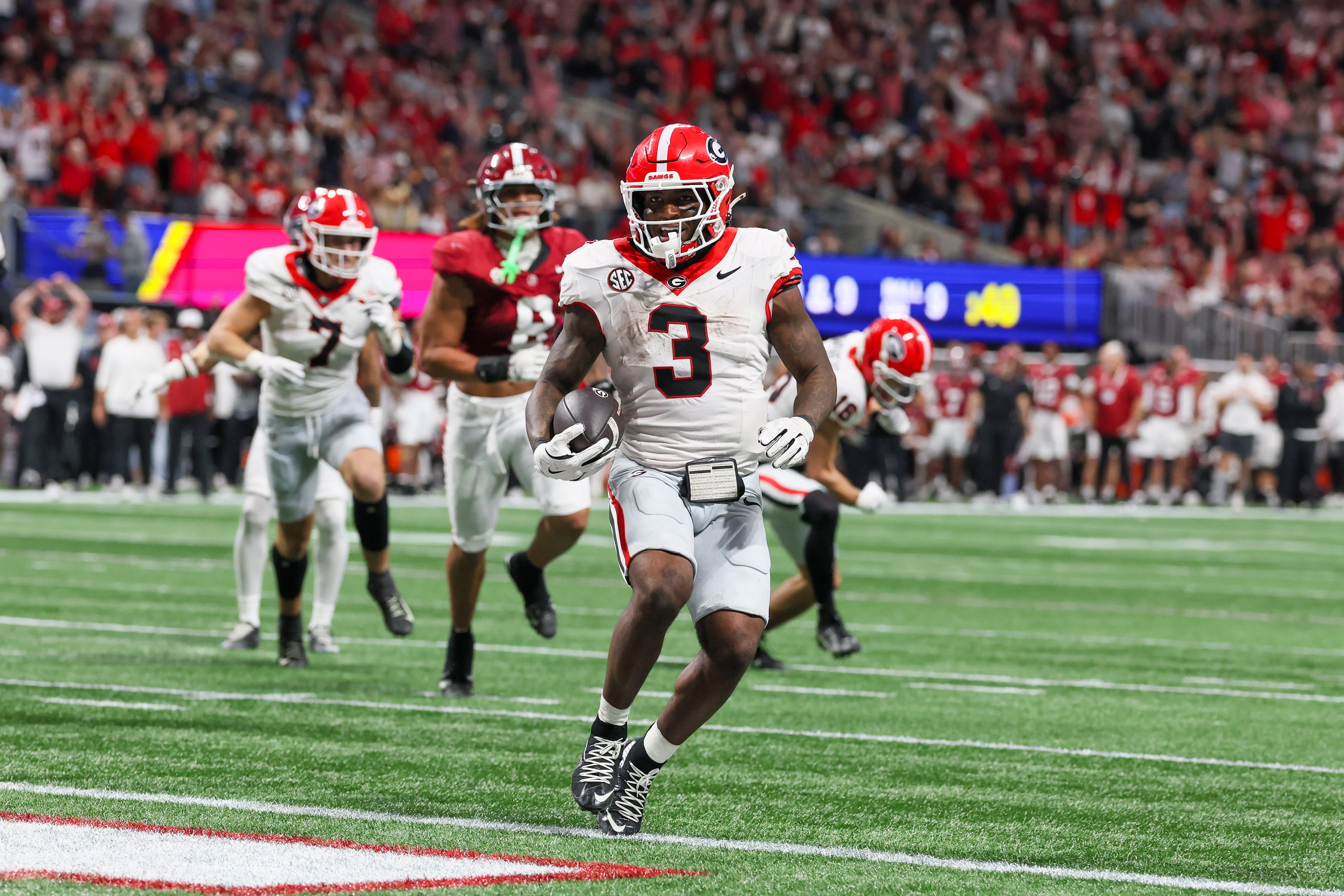 Georgia running back Nate Frazier (3) rushes for a nine yard touchdown against Alabama during the third quarter of the SEC Championship game at Mercedes-Benz Stadium, Saturday, Dec. 6, 2025, in Atlanta. (Jason Getz / AJC)