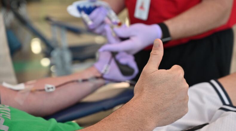 Brandon Hastings gives a thumbs-up as he donates blood during Buford City Schools’ annual Blood Drive at Buford Arena on Tuesday, March 31, 2020. With social distancing and extra measures to keep people safe from the coronavirus, blood supplies are getting dangerously low. (Hyosub Shin / Hyosub.Shin@ajc.com)