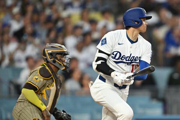 Los Angeles Dodgers' Shohei Ohtani drives in a run with a double during the third inning of a baseball game against the San Diego Padres, Monday, June 16, 2025, in Los Angeles. (AP Photo/Kyusung Gong)
