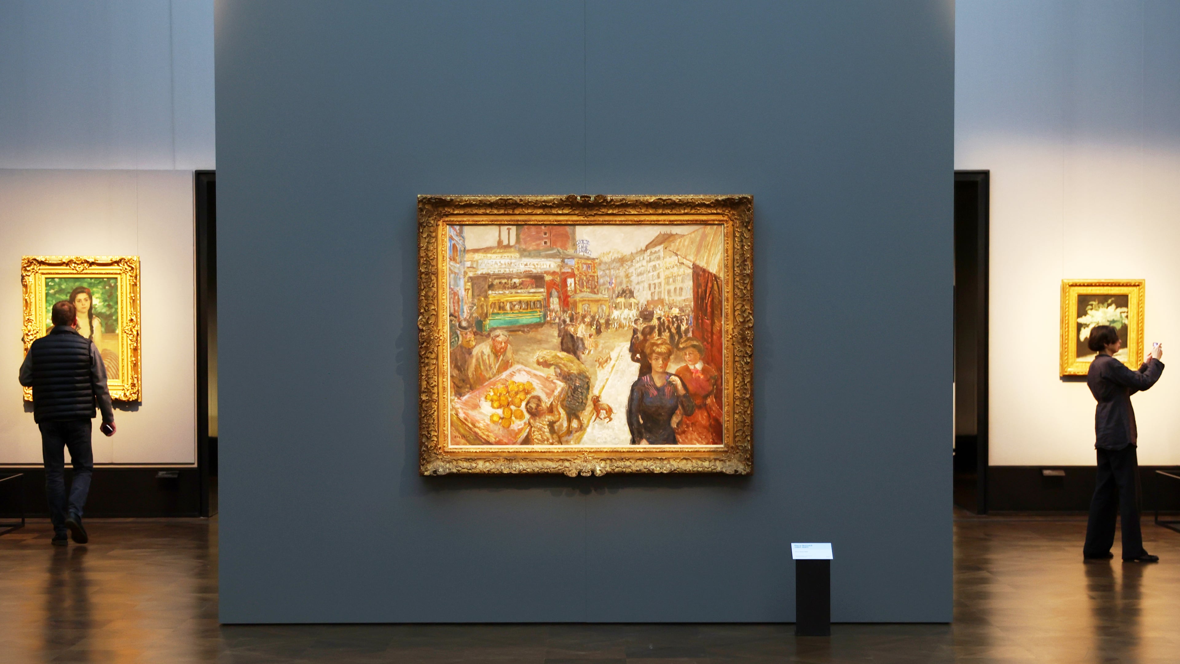 Journalists walks next to the painting "Place Clichy" from 1867-1947 by Pierre Bonnard during the press preview for the exhibition "The Scharf Collection: Goya – Monet – Cezanne – Bonnard – Grosse" at the Alte Nationalgalerie museum in Berlin, Wednesday, Oct. 22, 2025. (AP Photo/Maryam Majd)