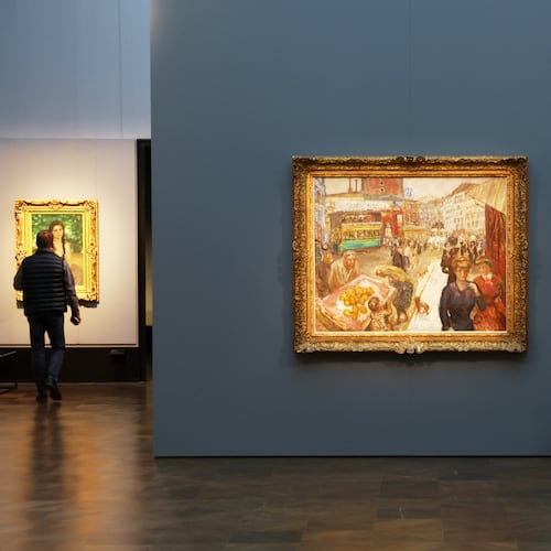 Journalists walks next to the painting "Place Clichy" from 1867-1947 by Pierre Bonnard during the press preview for the exhibition "The Scharf Collection: Goya – Monet – Cezanne – Bonnard – Grosse" at the Alte Nationalgalerie museum in Berlin, Wednesday, Oct. 22, 2025. (AP Photo/Maryam Majd)