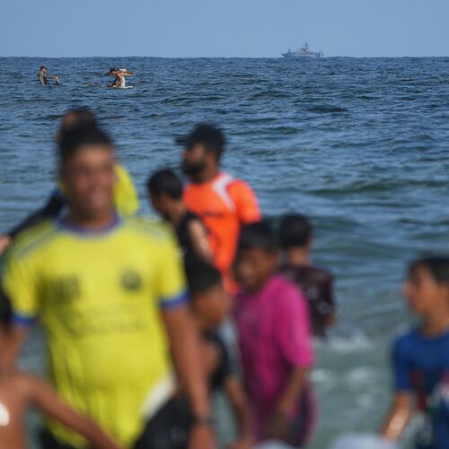 An Israeli navy vessel patrols off the Mediterranean coast as Palestinian children participate in the "Swimming with Gaza" event in Khan Younis, southern Gaza Strip, Friday, Aug. 21, 2026. (AP Photo/Abdel Kareem Hana)