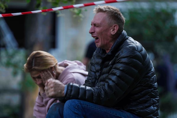 A father cries as his son is under the rubble of a multi-storey residential house destroyed by a Russian strike in Kyiv, Ukraine, on Tuesday, June 17, 2025. (AP Photo/Evgeniy Maloletka)