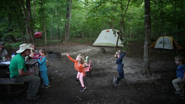 Grandchildren Gus Haschig, 5, takes a sip of water as sister Lydia, 3, cousins Hannah and Daniel Malkovich, 5 and 3, perform some expressive dancing for grandfather Dan Malkovich.]  At William O'Brien State Park exemplifies camping's popularity across the state ballooning as more Minnesotans seek inexpensive, close-to-home vacations and experience the mental and physical health benefits of spending time in nature. (Richard Tsong-Taatarii/Minneapolis Star Tribune/TNS)
