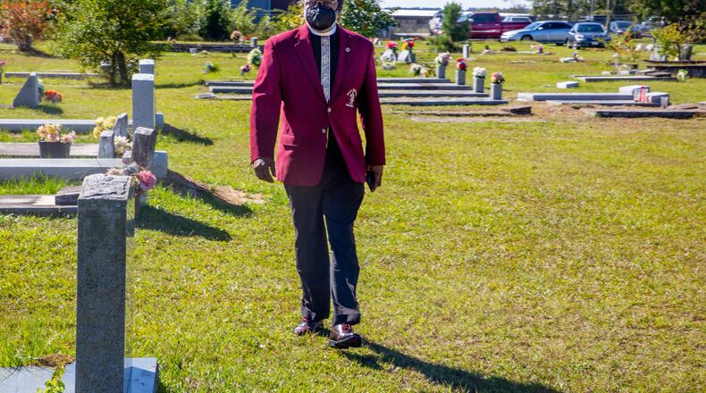 Funeral director Charlie A Hicks II of Hicks & Son Funeral Home heads to a graveside service near Mt. Zion Baptist Church in the Macon area. Hicks says that he’s buried people in their 20s, 30s, 40s — people who, if it weren’t for COVID-19, had their whole lives ahead of them. (Steve Schaefer for The Atlanta Journal-Constitution)