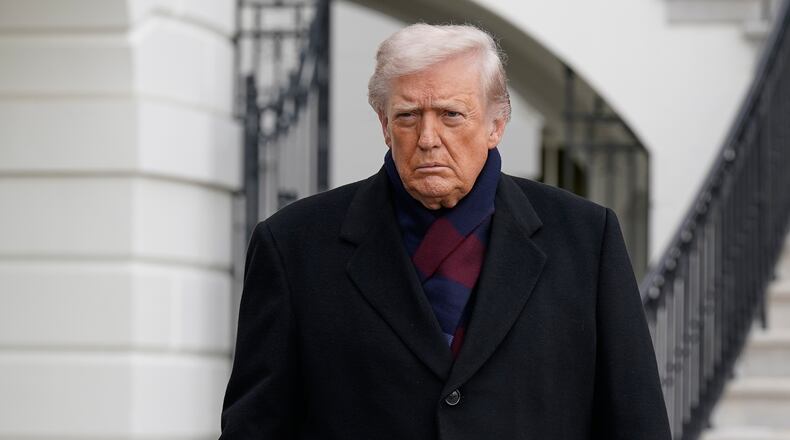 President Donald Trump talks to reporters as he departs from the South Lawn of the White House, Saturday, Dec. 13, 2025, in Washington, en route to Baltimore to attend the Army-Navy football game. (AP Photo/Jose Luis Magana)
