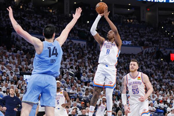 Oklahoma City Thunder forward Jalen Williams (8) looks to shoot over Memphis Grizzlies center Zach Edey (14) as Thunder center Isaiah Hartenstein (55) looks on during the first half in Game 1 of an NBA first-round playoff series, Sunday, April 20, 2025, in Oklahoma City. (AP Photo/Nate Billings)