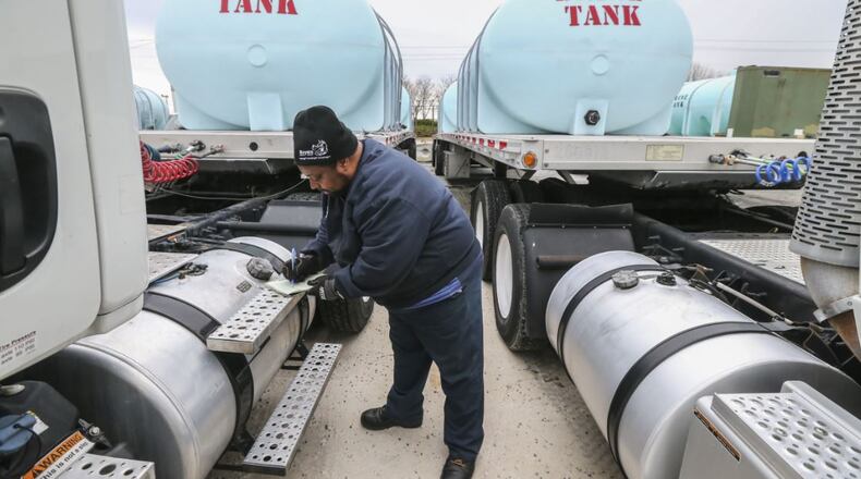 Jason Robinson logs data as he prepared the brine trucks at the Georgia Department of Transportation Maintenance Activities in Forest Park on Thursday. JOHN SPINK/JSPINK@AJC.COM