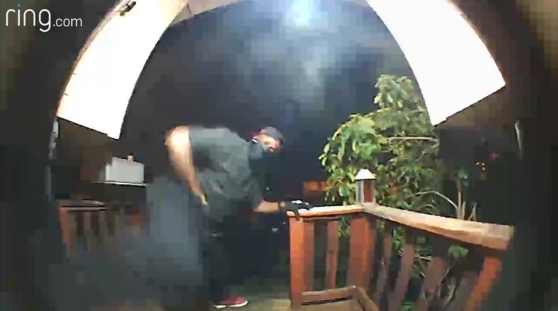 Security video image of a man trying to kick down the door of a home in Kent, Wash.