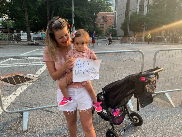 Nayara Castro and daughter Malu cheer on  Rafael Castro on Saturday morning. (Photo: Jeremy Redmon/AJC)