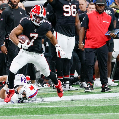 Atlanta Falcons running back Bijan Robinson avoids a tackle to run for his touchdown during the first half of an NFL football game against the Buffalo Bills at Mercedes-Benz Stadium in Atlanta on Monday, October 13, 2025. (Miguel Martinez/AJC)