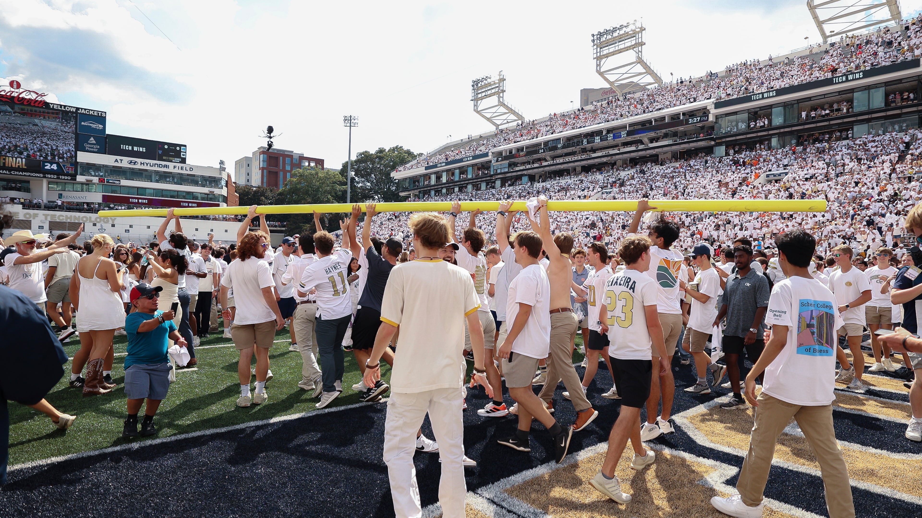 Georgia Tech fans walk on the field with the goal post after a game against Clemson on Sept. 13 at Bobby Dodd Stadium. (Colin Hubbard, /AP)