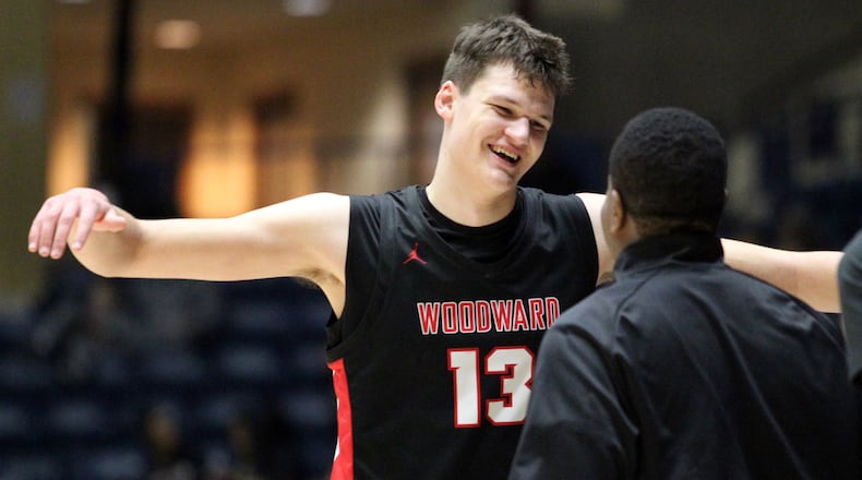 Woodward Academy Walker Kessler (13) celebrates with his coach after their win over Cross Creek of the Class AAAA boys title game Friday, March 6, 2020, at the Macon Centreplex, in Macon.