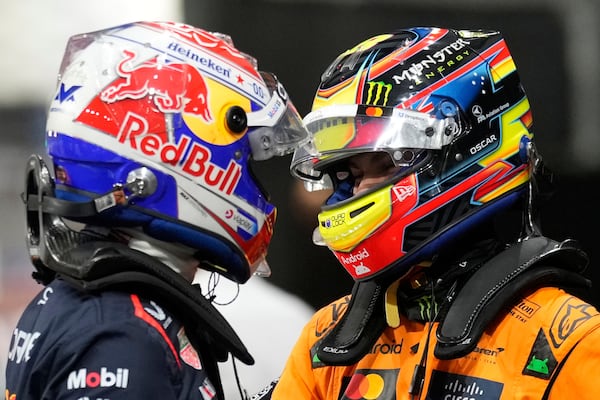 Red Bull driver Max Verstappen of the Netherlands, pole position, left, cheers with McLaren driver Oscar Piastri of Australia, second fastest time, after the qualifying session ahead of the Formula One Saudi Arabian Grand Prix at the Jeddah Corniche Circuit in Jeddah, Saudi Arabia, Saturday, April 19, 2025. (AP Photo/Darko Bandic)