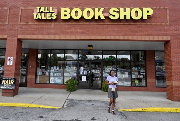 Aissatou Diallo leaves Tall Tales Book Shop after purchasing books on Wednesday, July 8, 2026, in Atlanta. The 46-year-old bookstore will face new competition this summer when a Barnes & Noble opens in the same shopping center. (Hyosub Shin/AJC)
