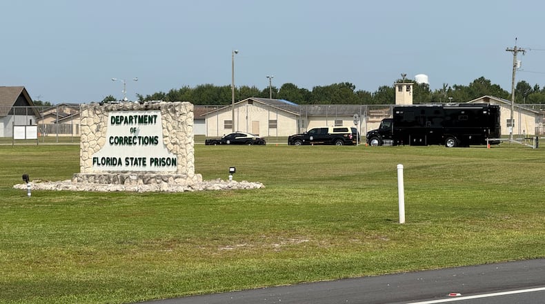 FILE - Law enforcement vehicles sit parked outside the Florida state prison in Starke, Fla., on Tuesday, July 28, 2026. (AP Photo/David Fischer, file)