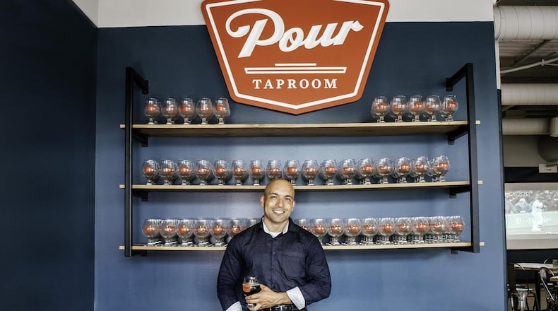 “People can come here and sample all the cool new stuff in one place,” says Atlanta Pour Taproom owner Ray Ballester, shown at the host stand. CONTRIBUTED BY LAUREN VEREEN / SALUT MEDIA