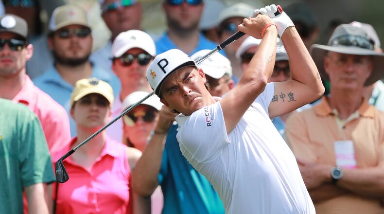 The gallery looks on as Rickie Fowler tees off on the fourth hole during his practice round Monday, April 8, 2019, for the Masters at Augusta National Golf Club in Augusta.