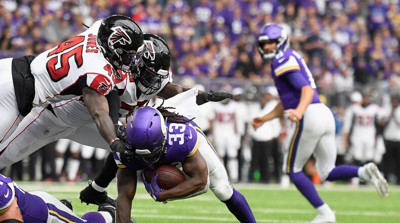 MINNEAPOLIS, MINNESOTA - SEPTEMBER 08: Richie Brown #49 and De'Vondre Campbell #59 of the Atlanta Falcons tackle Dalvin Cook #33 of the Minnesota Vikings just short of the goal line during the second quarter of the game at U.S. Bank Stadium on September 8, 2019 in Minneapolis, Minnesota. (Photo by Hannah Foslien/Getty Images)