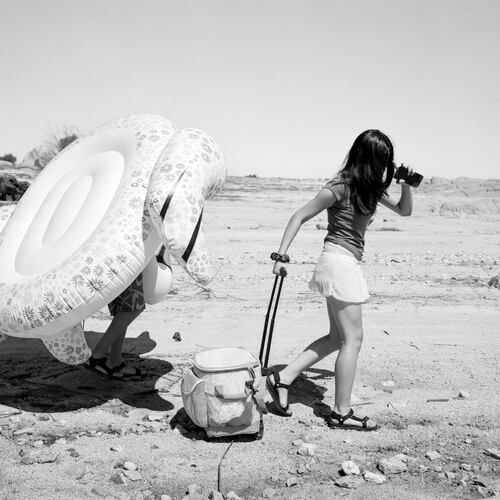 "Traveling to the Receding Lake II" (2021-2025) by Mimi Plumb from her series "The Reservoir." “People are kind of wandering aimlessly through this completely devastated landscape,” High Museum of Art photography curator Gregory J. Harris says of the series Plumb photographed at a parched reservoir outside Sacramento, California. (Photo courtesy of High Museum of Art/© Mimi Plumb)