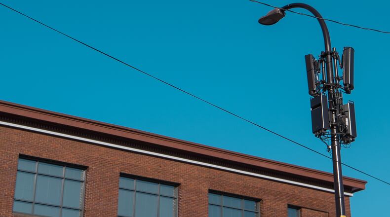 A small-cell cellular site, with antennas attached to a lamp post. (Wikimedia Commons)