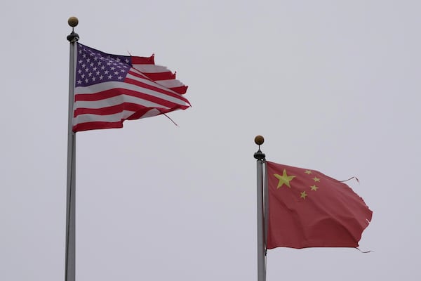 A flag of the United States flies next to a flag of China in Chinatown in San Francisco, Friday, April 18, 2025. (AP Photo/Jeff Chiu)