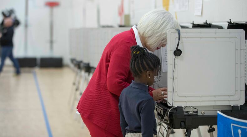12/05/2017, Atlanta, GA, - Sylvia Robinson, mother of Atlanta mayoral candidate Keisha Lance-Bottoms, casts her vote with her granddaughter, Lincoln Bottoms, by her side, during the run-off election at Fickett Elementary School, Tuesday, December 5, 2017. ALYSSA POINTER/ALYSSA.POINTER@AJC.COM