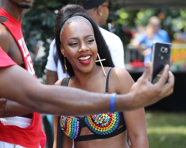 A fan snaps a selfie with Taija New behind stage as she prepares to perform during the Pure Heat Community Festival, part of Black Gay Pride weekend, at Piedmont Park on Sunday, Sept. 4, 2016, in Atlanta. Curtis Compton /ccompton@ajc.com