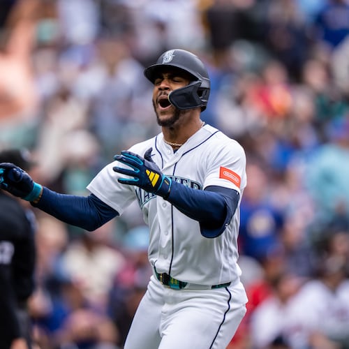 Seattle Mariners' Julio Rodríguez tosses his bat and celebrates after hitting a solo home run during the sixth inning of a baseball game against the Atlanta Braves, Wednesday, May 6, 2026, in Seattle. (AP Photo/Stephen Brashear)
