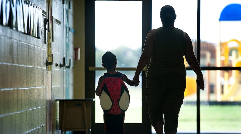 170816 TAYLOR, TEXAS:  Renee Long accompanies her son Jakevin Brown, 4, to his pre-k classroom on Wednesday, the first day of classes at T.H. Johnson Elementary School in Taylor.  T.H. Johnson Elementary School, with approximately 375 students, is for pre-k and kindergarten students in Taylor.  Andy Sharp / For the American-Statesman.