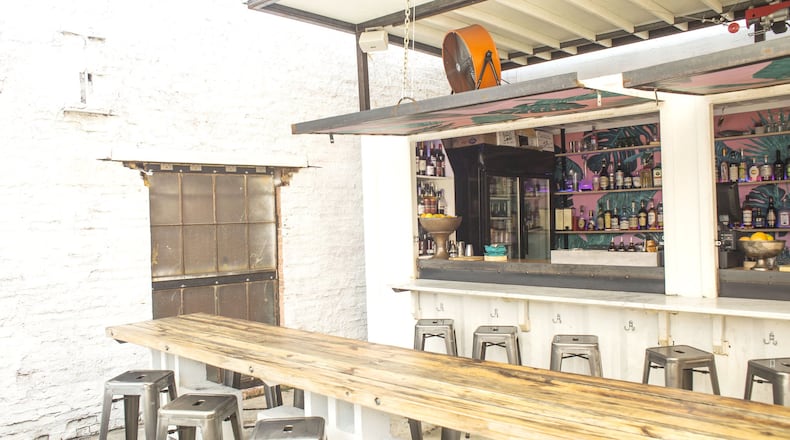 At the 8Arm restaurant on Ponce de Leon Avenue in Midtown, a white shipping container is rigged up as its bar. (Chad Rhym/ Chad.Rhym@ajc.com)