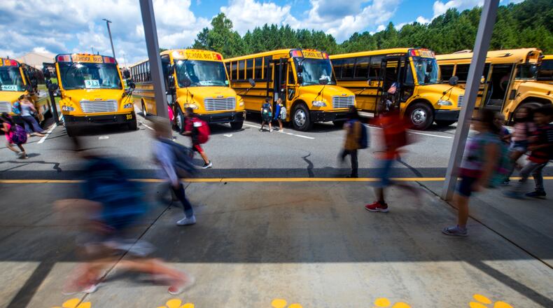Bus riders at Liberty Elementary School in Canton finish their school day and start their ride home in Cherokee County on Thursday, Sept 2, 2021.  Substitute teachers have become even more difficult to find since the pandemic as the need grows and students are back in class.  Cherokee has begun assigning central office workers to classrooms to staff needed substitute. (Jenni Girtman for The Atlanta Journal-Constitution)