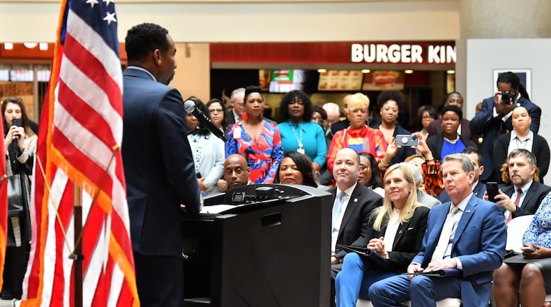 Gov. Brian Kemp looks on as Atlanta Mayor Andre Dickens speaks at an event Tuesday at Hartsfield-Jackson International Airport targeting human trafficking. Kemp and Dickens appear to have a closer working relationship than the governor had with the previous mayor, Keisha Lance Bottoms. AJC/Hyosub Shin.