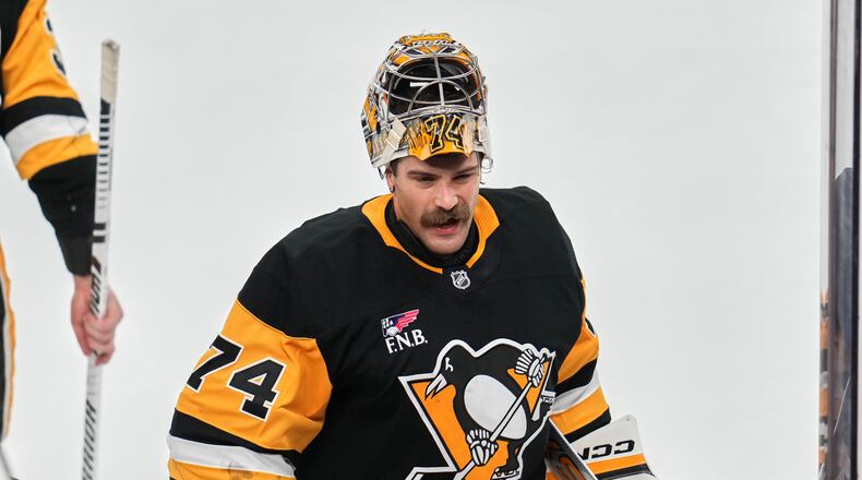 FILE - Pittsburgh Penguins goaltender Stuart Skinner takes a timeout during the first period of an NHL hockey game against the Dallas Stars in Pittsburgh, March 28, 2026. (AP Photo/Gene J. Puskar, File)