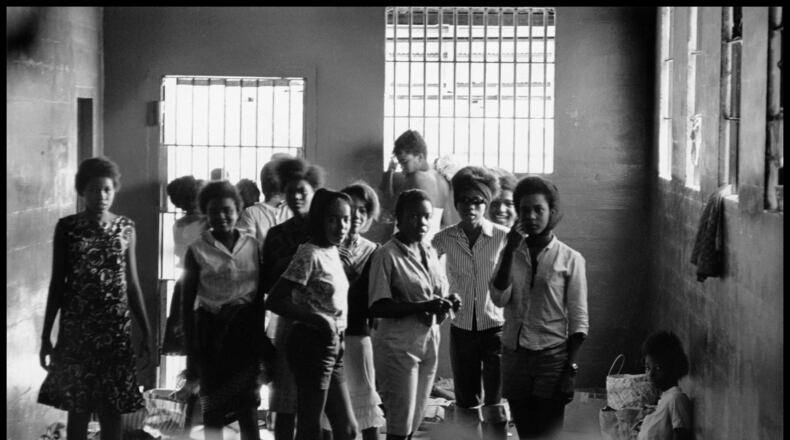 August 1963. Young women are held in the Leesburg Stockade after being arrested for demonstrating in Americus. They have no beds or sanitary facilities. Left to right — Melinda Jones Williams, Laura Ruff Saunders, Mattie Crittenden Reese, Pearl Brown, Carol Barner Seay, Annie Ragin Laster, Willie Smith Davis, Shirley Green and Billie Jo Thornton Allen. Sitting on the floor: Verna Hollis. Photo by and courtesy of DANNY LYON