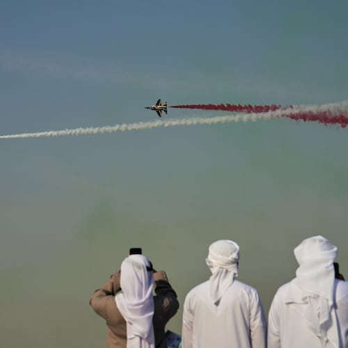 Emirati men take photos of Fursan Al Emarat, the aerobatics demonstration team of the United Arab Emirates Air Force during the Dubai Air Show in Dubai, United Arab Emirates, Tuesday, Nov. 18, 2025. (AP Photo/Fatima Shbair)