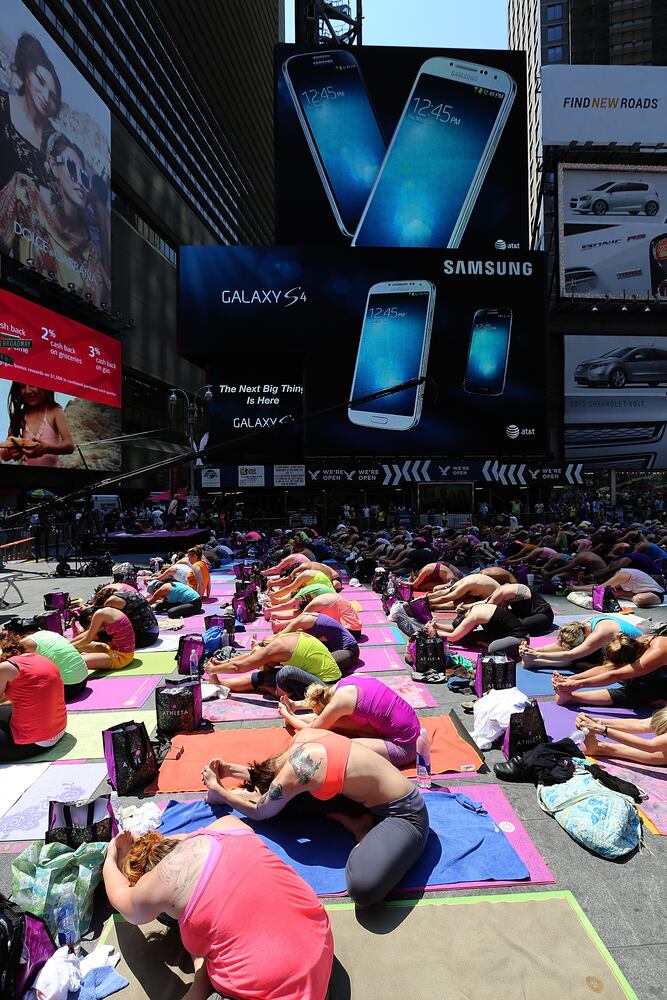 Enthusiasts perform yoga in Times Square to mark summer solstice, June 21, 2013