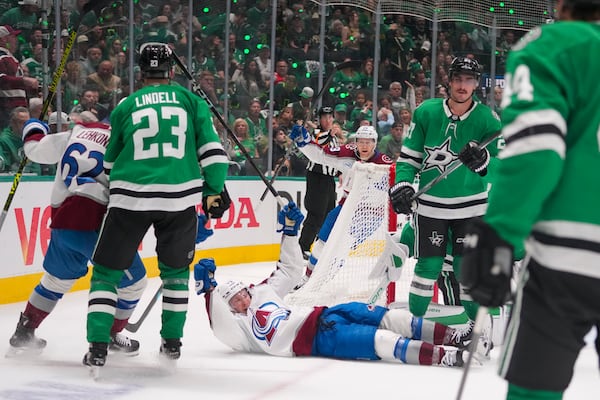 Colorado Avalanche right wing Logan O'Connor, bottom, reacts after scoring a goal against the Dallas Stars during the second period in Game 2 of a first-round NHL hockey playoff series Monday, April 21, 2025, in Dallas. (AP Photo/Julio Cortez)