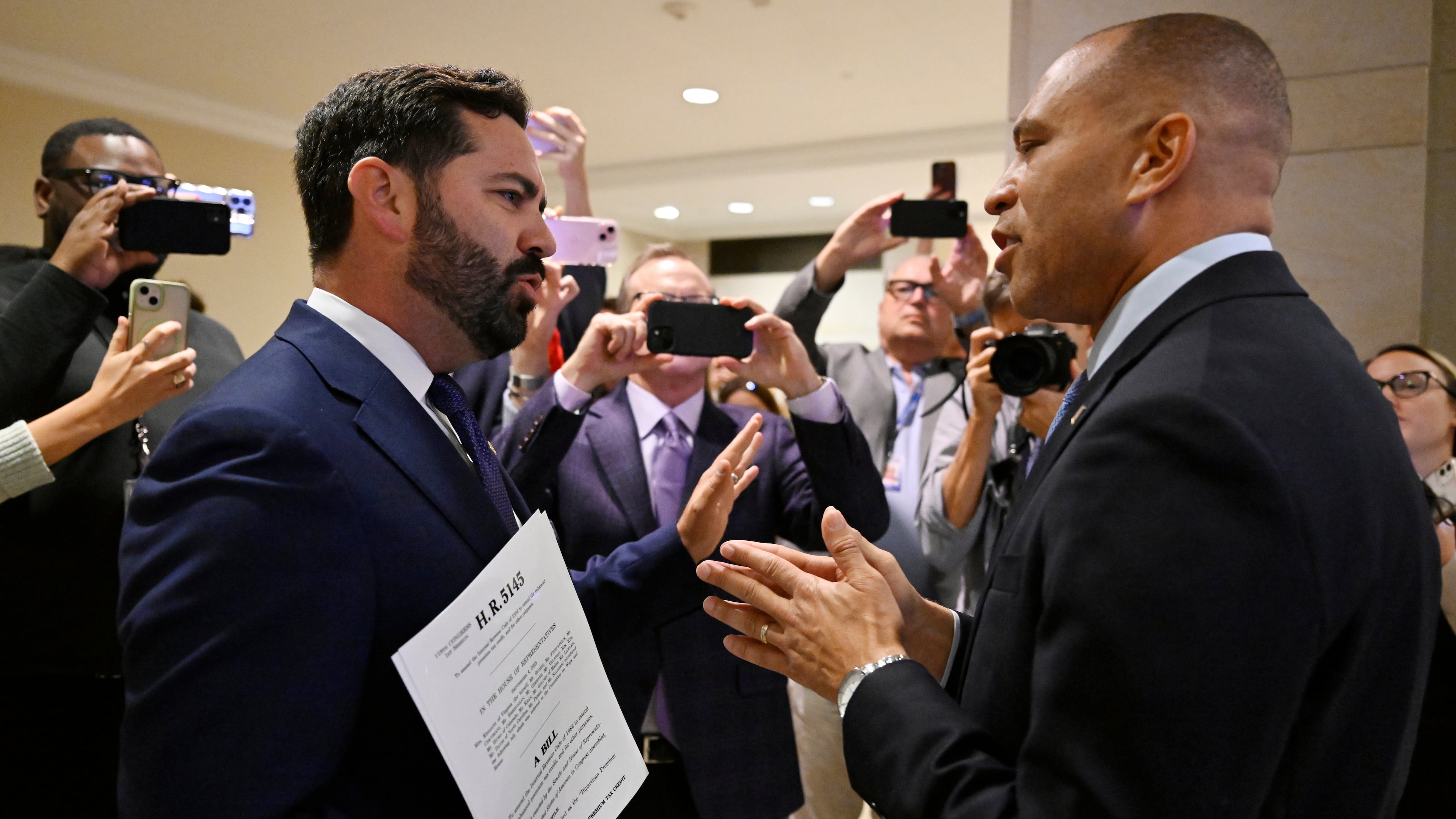 Rep. Michael Lawler, R-N.Y., left, confronts House Minority Leader Hakeem Jeffries, D-N.Y., in a heated discussion to endorse House bill H.R.5145 that would extend the American Rescue Plan Act of 2021 (ARPA) and the Inflation Reduction Act of 2022 at the U.S. Capitol on Wednesday, Oct. 8, 2025, in Washington. (AP Photo/John McDonnell)