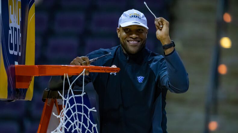 Jarvis Hayes, here cutting down the net after Georgia State won the 2022 Sun Belt Conference Tournament in Pensacola, Fla, has been retained on the staff by new coach Jonas Hayes, his twin brother.